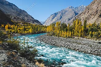Autumn scene, blue turqu oise water of Gilgit river flowing through Gupis,Pakistan.