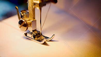 4K footage. close up sewing needle on white fabric canvas with a sewing machine
