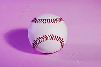 Baseball on a Pink color background and red stitching baseball.