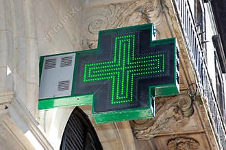 Green cross Pharmacy sign in street building store