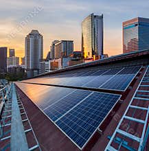 Solar Panel Photovoltaic installation on a Roof of factory, sunny blue sky background, alternative electricity source -