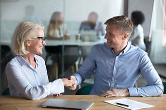 Happy male client employee handshake broker hr manager at meeting