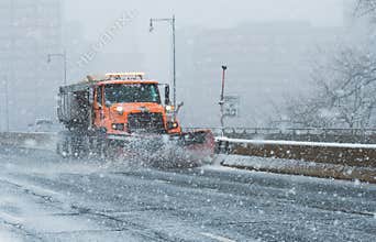 Snowplow Truck cleans the highways and interstate during Blizzard conditions during Nor`Easter in New England USA