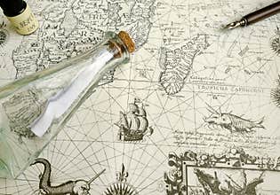 Antique treasure map and manuscript pen