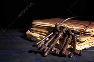 Bunch of old vintage keys with books on table, space for text