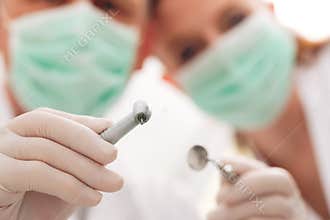 Dentist, Assistant and drill in a treatment