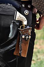Western pistol gun with ivory handle grip in leather holster gun belt worn by old west cowboy