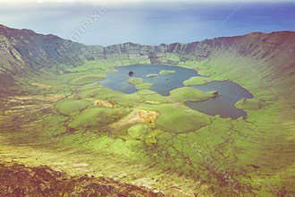 Aerial view of volcanic crater Caldeirao with a beautiful lake on the top of Corvo island. Azores islands, Portugal