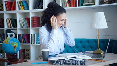 Smiling beatiful female student using video confirence with her teacher and groupmates at campus