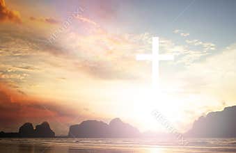 Cross on blurry sunset background