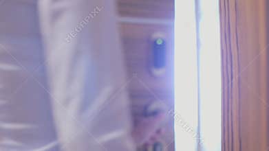 A young woman opens the door of his hotel room using an electronic key card
