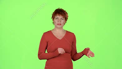 Redhaired woman talks about the pros of the goods. Green screen