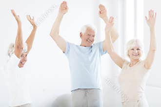 Seniors with hands up