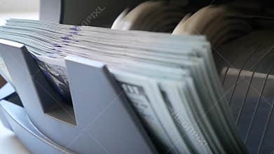 Cash money counting machine. Banknote counter are counting hundred dollar bills.