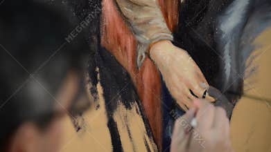 Artist with a brush using oil painting