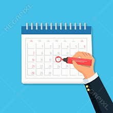 Close-up businessman hand with calendar and red marker. Concept mark on the calendar.