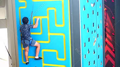 Boy climbing a wall indoor