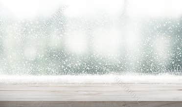 Empty wood table top with snowfall of winter season background.For christmas day and new year idea concept.