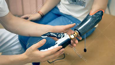 Robotic limb, prosthesis. Girl use bionic 3d printed arm for the first time. 4K.