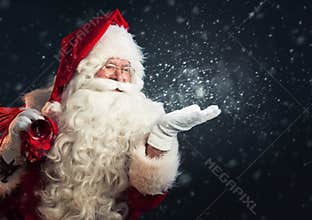 Santa Claus blowing snow of his hands