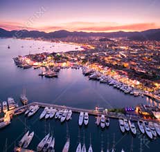 Aerial view of boats and beautiful city at night in Marmaris, Tu