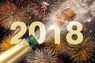 Popping champagne and fireworks at new years eve 2018