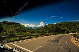 Highway among Hills out of Car Window