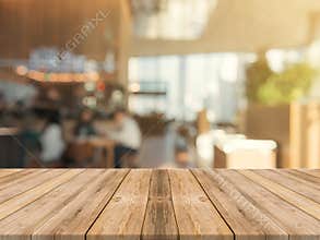 Wooden board empty table top on of blurred background. Perspective brown wood table over blur in coffee shop background