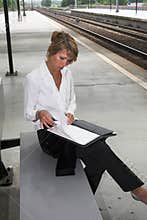 Checking her notes at the trainstation