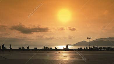 Embankment and central square in Nha Trang Sea View. Vietnam. Sunset with the sun in yellow colors.