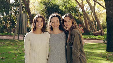 Girls in the park hugging and smiling