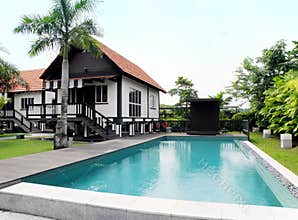 Tropical style house with pool and landscaping