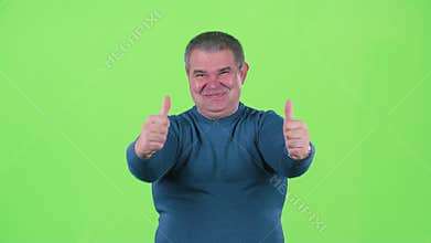 Middle aged man is showing a thumbs up. Green screen