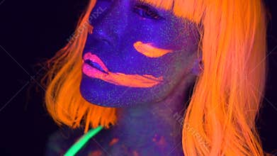 woman with UV fluorescent face and body makeup