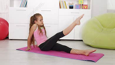 Young girl exercising at home - leg training