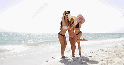 Girls On Beach Taking Selfie Photo On Cell Smart Phone, Cheerful Women In Bikini Taking Off Straw Hats On Summer Holiday
