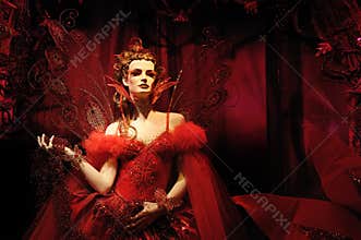 High fashion model in red dress and fantasy s