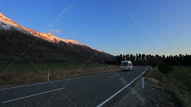 Camper van passing highway in aspiring national park south land new zealand