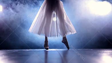 A ballerina steps from one foot to another.