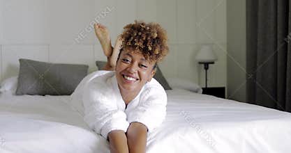 Charming model on hotel bed