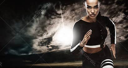 A strong athletic, female sprinter, running at sunrise wearing in the sportswear, fitness and sport motivation concept