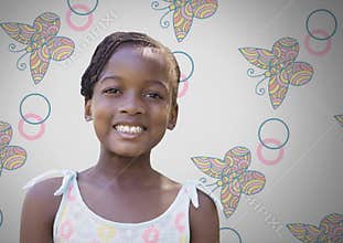 Girl against grey background smiling and butterfly patterns
