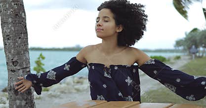 Woman enjoying wind on shoreline