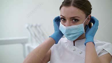 Dentist doctor in dental clinic put on face mask