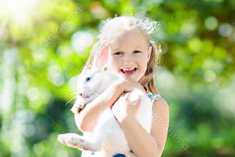 Child with rabbit. Easter bunny. Kids and pets.