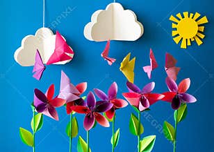 Origami paper flowers, butterflies, clouds and sun.