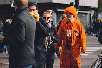 Man dressed in orange, crazy wig, King`s Day festivity