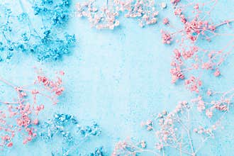 Wedding flower frame on blue pastel background top view. Beautiful floral pattern. Flat lay. Woman or mother day greeting card.