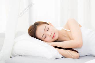 Beautiful asian young woman sleeping lying in bed with head on pillow comfortable and happy.