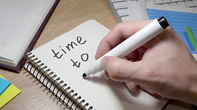 Man writing time to start at note. Motivation for changes.